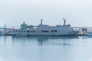 Gray navy warship moored in the port of Callao, Peru.