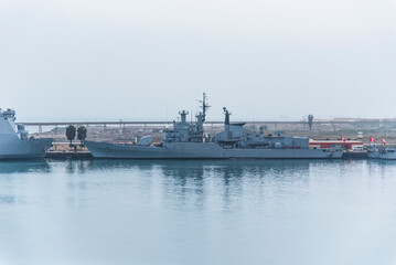 Gray navy warship moored in the port of Callao, Peru.