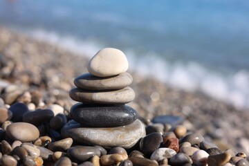 Stack of wet stones near sea on beach, closeup