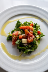 homemade recipe for green salad with tomato and oil