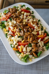 homemade recipe for fresh salad with ingredients such as apple or meat
