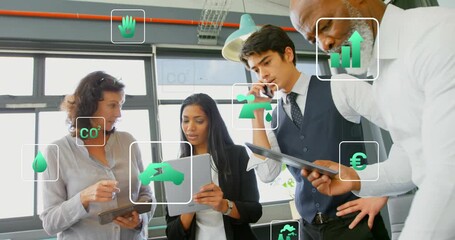 woman pointing tablet initiating floating green icons while team analyzing green finance metrics - Powered by Adobe