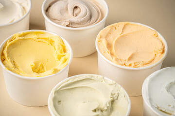 Variety of colorful ice cream in white cups