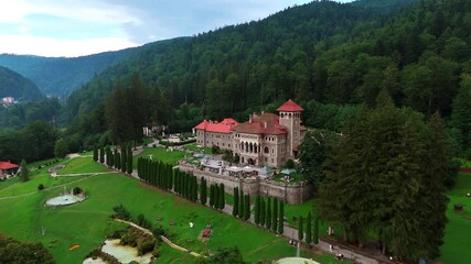 Beautiful old castle in Busteni, Romania surrounded by the lush greenery. Famous Cantacuzino Castle from drone footage.