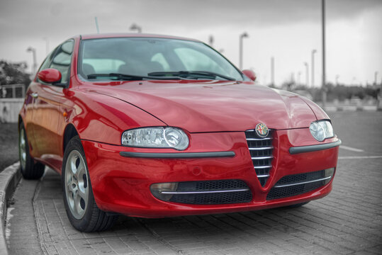 Red Alfa Romeo 147 parked on the street
