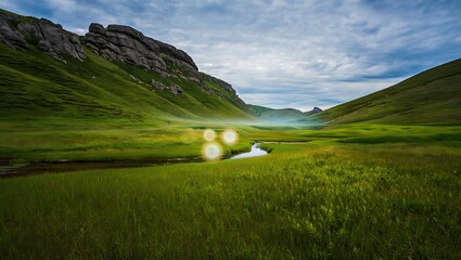 Rolling green hills and rocky mountain landscape in a peaceful valley