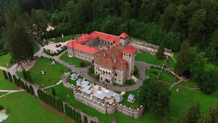 Well-kept territory of a famous Romanian landmark from drone. Footage above the Cantacuzino Castle in Busteni, Romania.