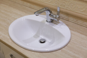Modern bathroom sink with chrome faucet on marble countertop, hygiene and interior concept.