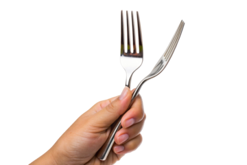 Hand holding silver fork against black background highlighted by studio lighting in close-up shot