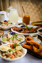 Close up of Tahitian Breakfast (poisson cru, fish, firi firi, coffee, juices) 