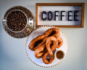 Tahitian firi firi (coconut donuts) with coffee cup, coffee beans