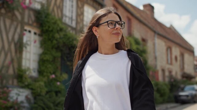 Tourist walking through the picturesque village of Gerberoy in France. Beautiful old streets, architecture of historic houses, travel and tourism, countryside of Europe.