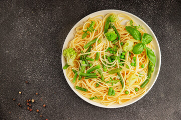 Spaghetti vegetables green peas, broccoli, string beans, kohlrabi vegetarian pasta tasty snack...