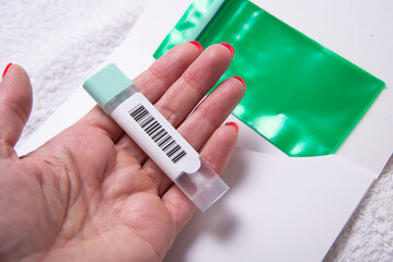 Woman Holding Stool Collection Tube for Colon Cancer Screening with Barcode
