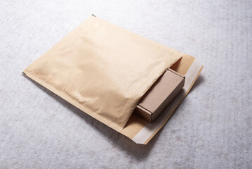 Brown Cardboard Box Inside Open Bubble Mailer Plastic Padded Envelope
