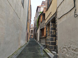 Narrow medieval alleyway between old stone houses