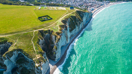 Aerial view of Etretat cliffs on the Normandy coast in France, with dramatic white chalk...