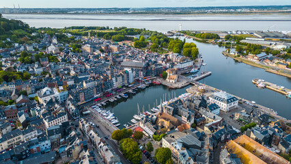 Aerial view of Honfleur, a charming small town in Normandy, France, with its picturesque harbor, historic buildings, and colorful houses, a popular destination for tourism, photography, and cultural 