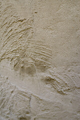 The texture of an untidy plastered wall where you can see the lines