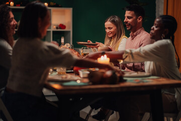Friends sharing food, celebrating christmas or thanksgiving together