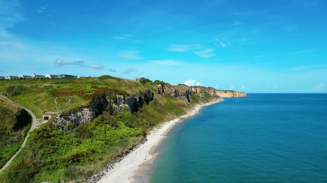 Aerial view of Omaha Beach in Normandy, France, with Flower Camping Omaha Beach nearby, historic WWII D-Day landing site, sandy coastline, green fields, and holiday atmosphere