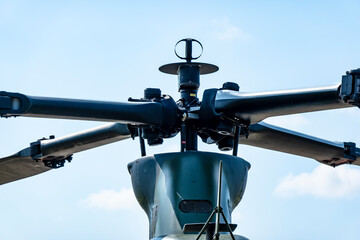 A close-up view of the main rotor of a military helicopter