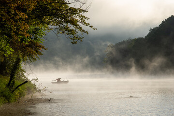 Dewey Lake  Foggy Dawn with fisherman.  Jenny Wiley Kentucky State Park. 