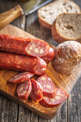 Sliced smoked ​​sausage on cutting board.