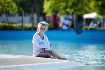 Girl enjoying a sunny day by the pool