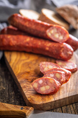 Sliced smoked ​​sausage on cutting board.