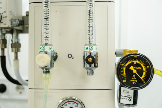 Close-up view of a medical oxygen concentrator displaying flow meters and a vacuum gauge, essential equipment for delivering controlled oxygen supply in a hospital environment