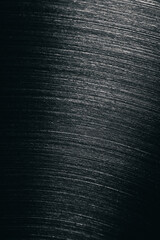 Fototapeta premium Close-up of brushed stainless steel surface showing fine diagonal lines and metallic texture, often seen in cookware, appliances, or industrial materials.