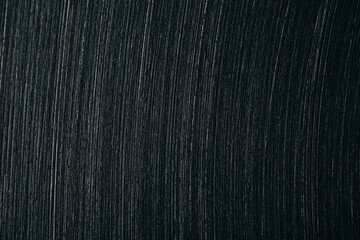 Close-up of brushed stainless steel surface showing fine diagonal lines and metallic texture, often seen in cookware, appliances, or industrial materials.