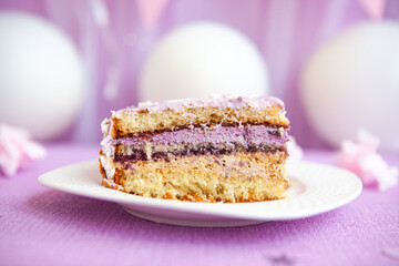 Birthday piece of cake in light purple decorations, with white air balloons, beautiful dessert 