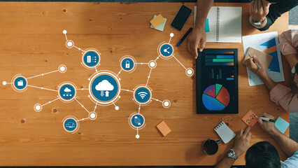 Collaborative Workspace with Data Visualization and Cloud Computing Elements Overlaid on a Wooden Table, Showcasing Technology Engagement and Team Dynamics. Amity