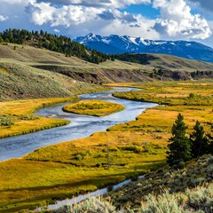 A meandering river winds through a valley, framed by rolling hills and snow-capped mountains, in a serene autumnal landscape.