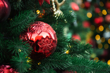 Christmas tree with red ball and lights garland. Xmas card. Close up. Winter holiday spirit....