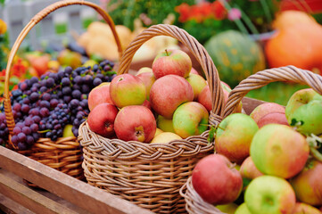 Fresh apples in baskets at outdoor farmers market