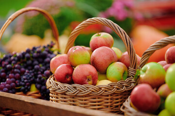 Fresh apples in woven basket at outdoor market