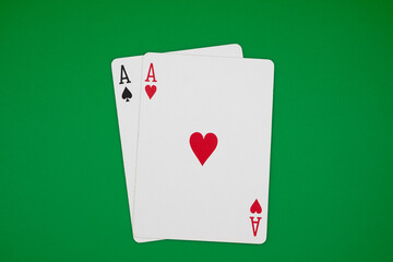 A pair of aces on green background, symbolizing casino games, gambling, and poker tournaments.