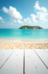 Fototapeta premium White wooden table top in foreground provides empty copy space. Blurred tropical ocean beach background with golden sand, calm turquoise water. Distant green island, clear blue sky, fluffy white