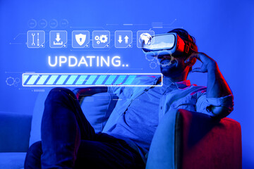 A man is seated comfortably, immersed in a virtual reality experience as he updates software on his device. The atmosphere is bright and engaging, showcasing technology impact on leisure. XDMCP