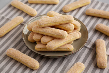 Savoiardi biscuits on a plate, side view.