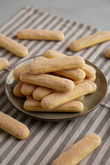 Savoiardi biscuits on a plate, side view.