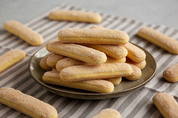 Savoiardi biscuits on a plate, side view.