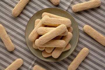Savoiardi biscuits on a plate, top view.