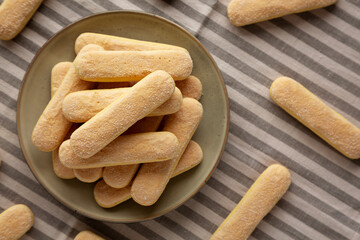 Savoiardi biscuits on a plate, top view.