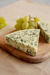 Delicious Cheese Danablu on a wooden board, side view.