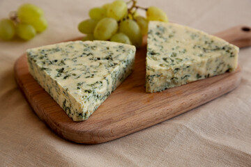 Delicious Cheese Danablu on a wooden board, side view.