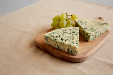 Delicious Cheese Danablu on a wooden board, side view. Copy space.